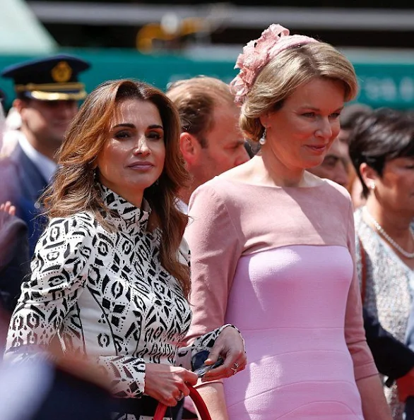 Queen Mathilde and Queen Rania visit Bruges, Belgium. Queen Rania wore Louis Vuitton dress and Louis Vuitton bags. Queen Mathilde wore Natan dress