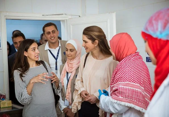 Queen Rania visited the Ballas Secondary School for Girls in Ajloun Governorate. Queen Rania style; wore Valentino blouse and Prada clutch bag