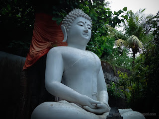 Natural Garden With Big White Buddha In Meditation Statue At Buddhist Monastery In Bali Indonesia