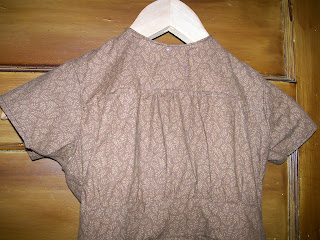 Yoked bodice with jewel neck. Yoked bodice with jewel neck.