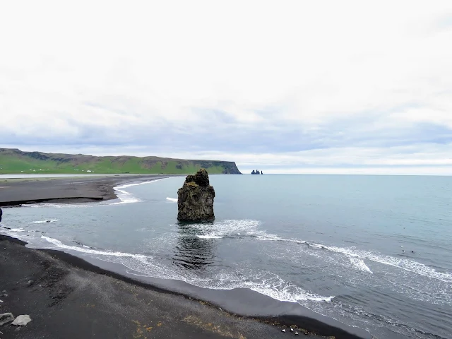 Large rock in the water near Dyrhólaey Peninsula black beaches along the South Coast of Iceland