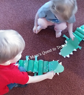 children playing with green alligator craft