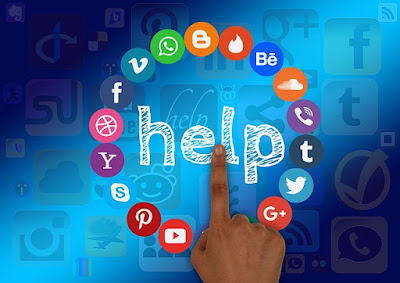 circle of social media and website icons with help written in the middle - a finger is pushing the word help
