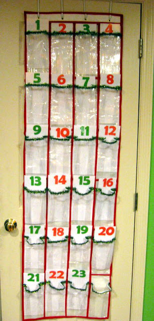 A homemade Grinch advent calendar made of a plastic shoe organizer