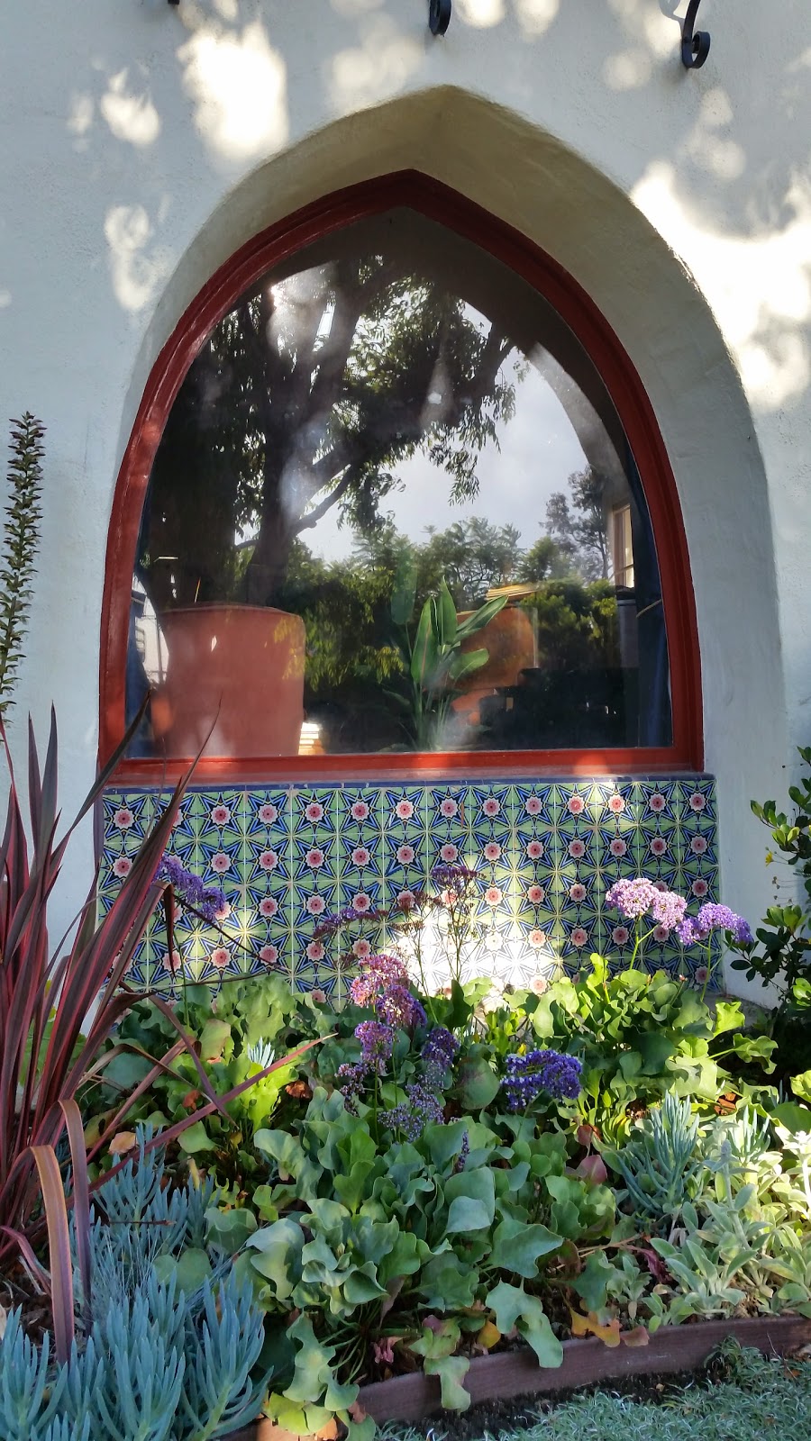 These brightly colored tiles are grouped beneath a Moorish arch to create a colorful tribute to Spanish Revival Architecture