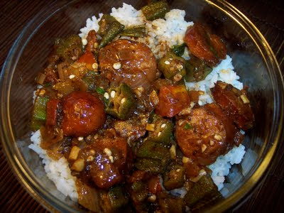 Bowl of stewed okra with tomatoes and andouille over rice.