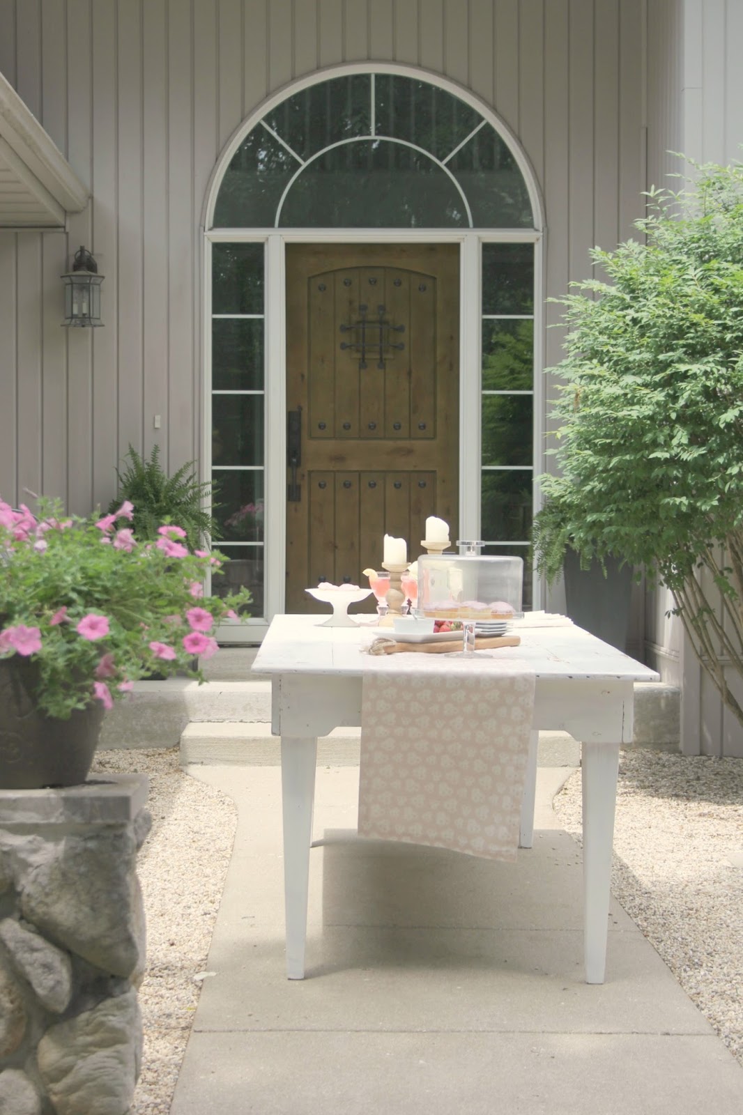 Farm table in French inspired pea gravel courtyard - Hello Lovely Studio