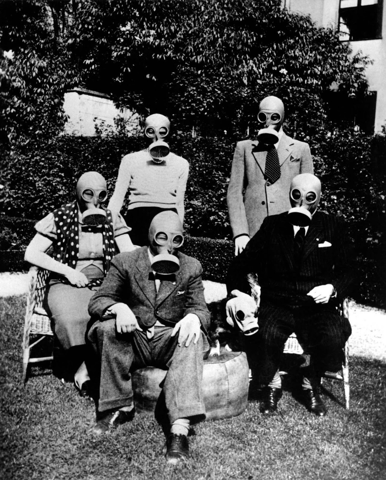 An American family and their dog at the beginning of World War II show off their gas masks in preparation for a possible gas attack in 1940 in Berlin, Germany.