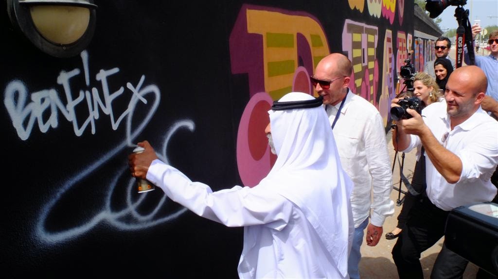 Ahead of his debut solo in the Gulf region, British artist Ben Eine has just completed a 40-metre  outdoor mural  on the walls  of  the  British  Embassy  in  Abu  Dhabi. Working alongside students from Zayed University , the 40-meters Embassy mural reads: "Beauty Is In The Eye Of The Beholder"; a comment on the juxtaposition of the traditional and the modern that encapsulates the dynamics of this unique region.