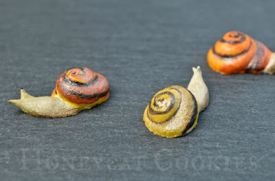 Close up of fully painted tiny royal icing snails