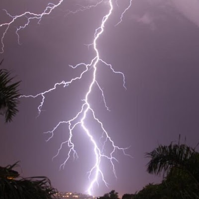 large lightning strike in purple night sky