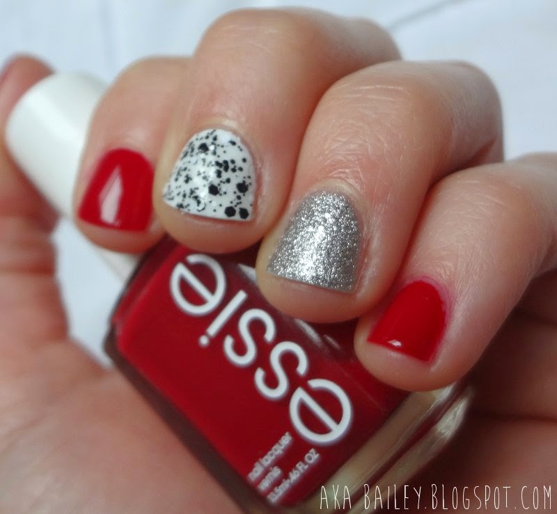 Red nails with silver accent and black and white accent