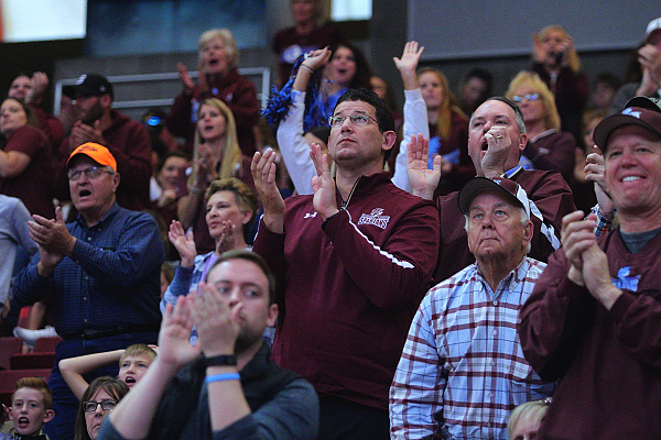 Parents and SJO fans cheer for their team during at timeout