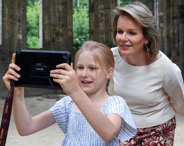 Queen Mathilde wore Dries Van Noten trousers, white bell Sleeve Stretch Crepe Top. Crown Princess Elisabeth and Princess Eleonore