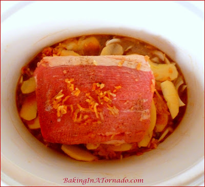 Slow Cooked Apple Cider Beef Roast, a roast slow cooked with onions and apples in a cider based braise. An easy special meal for any night. | Recipe developed by www.BakingInATornado.com | #SlowCooker  #beef #dinner