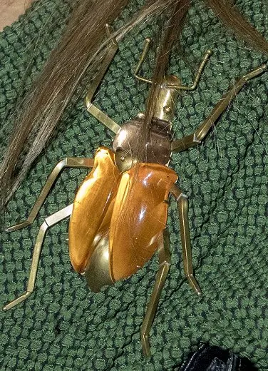 Queen Maxima wore a Jantaminiau Pantsuit from the Attic 2016 collection. Garavelli Tiger Eye Gold Beetle Brooch