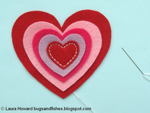 Sewing the first felt heart in place