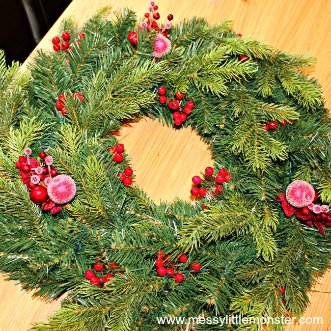 DIY Christmas wreath craft.  Use a shop bough wreath and add decorations to make it your own. An easy way to create a personal wreath in minutes!