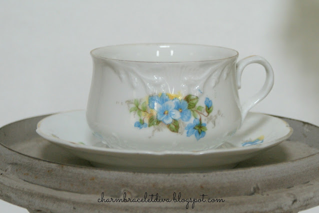 white tea cup with blue flowers and saucer