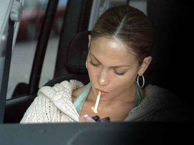 Jennifer Lopez lighting a cigarette.