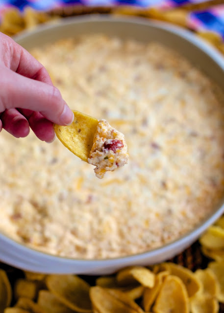 Warm Crack Dip - The ORIGINAL recipe!! Sou cream dip loaded with cheddar, bacon and ranch dip - this stuff is SO addicting! This is always the first thing to go at a party! I could make a meal out of it! Serve with Fritos and tortilla chips! Can make ahead and refrigerate before baking.