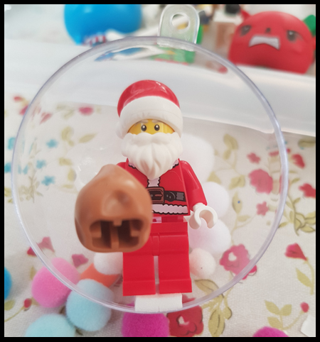 Adding a little foam pad to the Lego Minifigures to ensure they don't fall over in the new Christmas Baubles