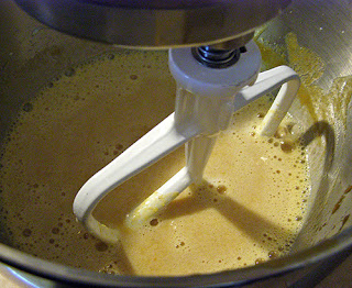 Mixer on low speed mixing eggs, milk, and pumpkin
