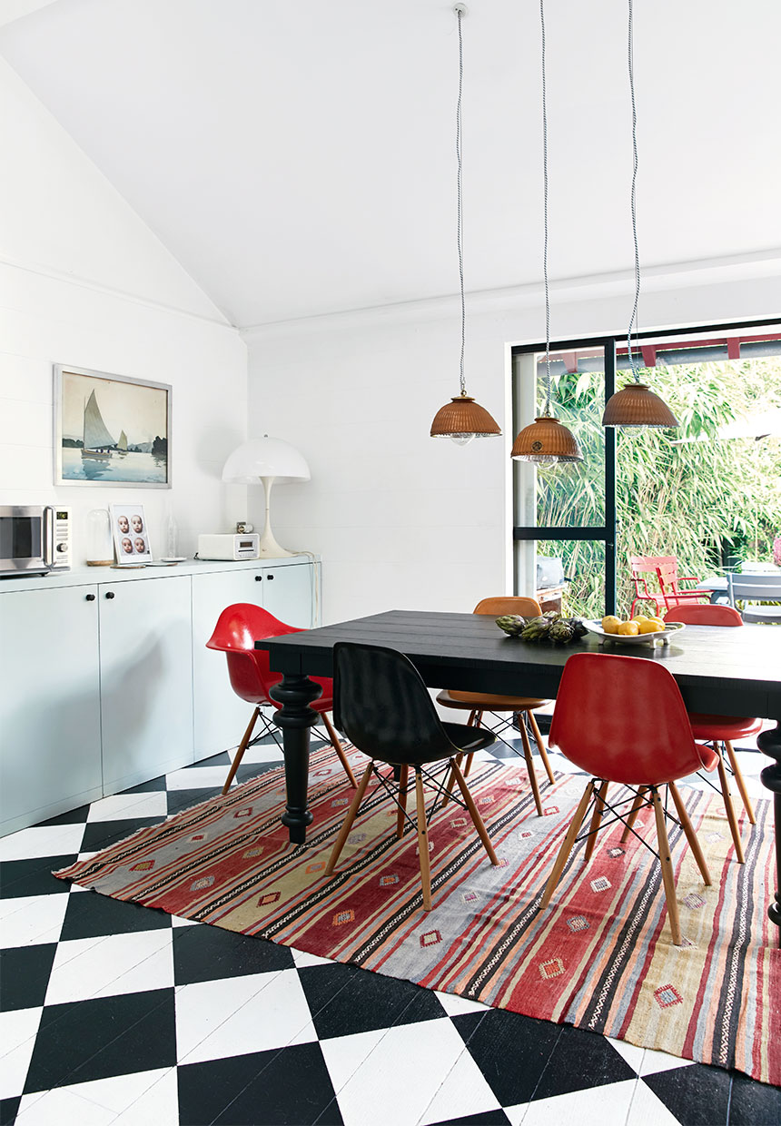 robin egg kitchen cabinets, ornamental rug and eames chairs around the dining table