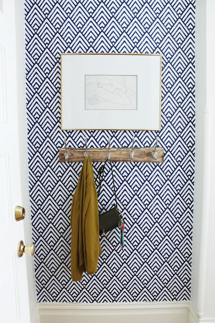 Wallpapered entryway with artwork by Lindsey Crafter