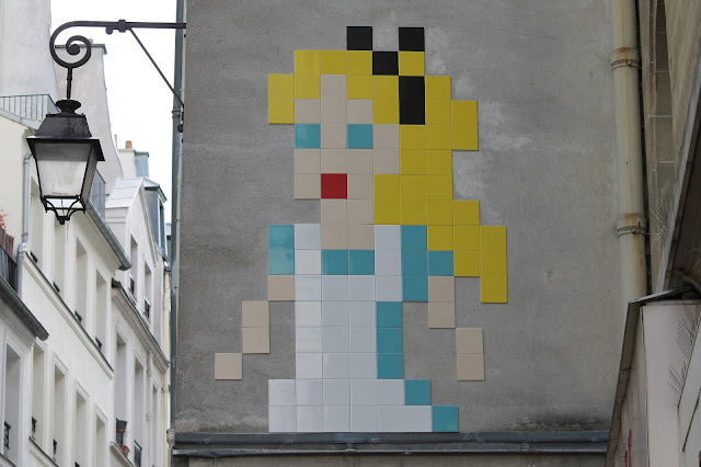 After a smiley version of Napoleon a couple days ago, Invader is once again back on the streets of Paris with a brand new pixelated design. The anonymous French artist created this large-scale rendering of Alice In Wonderland using mosaic tiles, a design which is now known as "PA_1170".