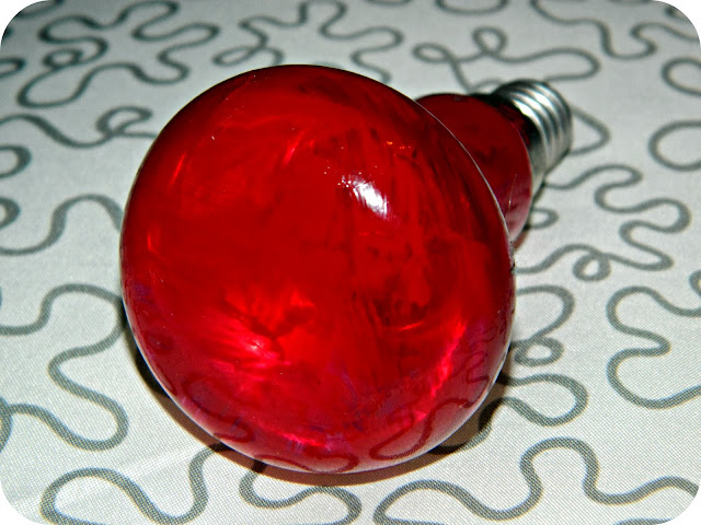 Red lightbulb painted with nail polish