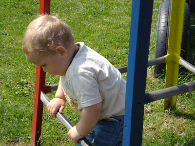 Baby Boy having a climb on a climbing frame