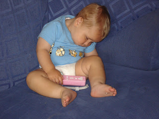 Baby Boy asleep holding on to a wii controller