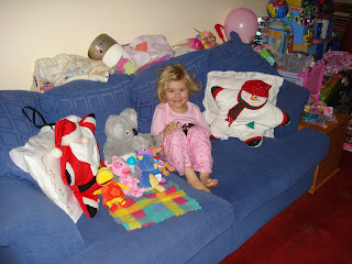 Top Ender sitting on the sofa with Toys and Christmas pillows watching a Christmas film