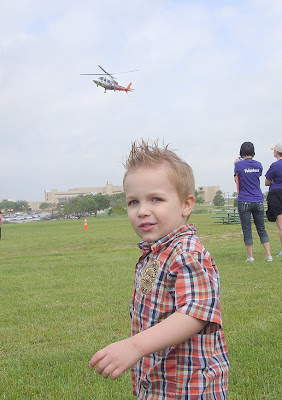 child pointing at helicopter