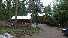 Woodshed in front, house behind