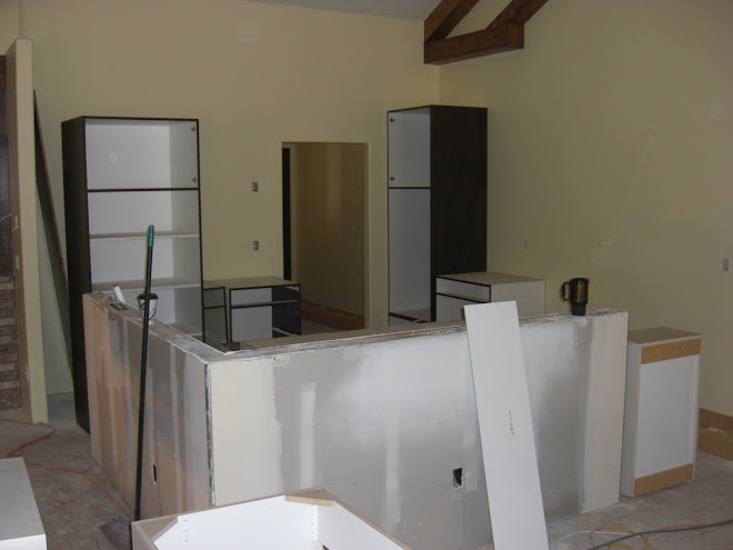 Some of the kitchen cabinets being hung