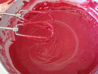 A bowl of red frosting.