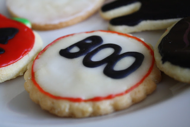 Close up of a cookie with boo written on it.