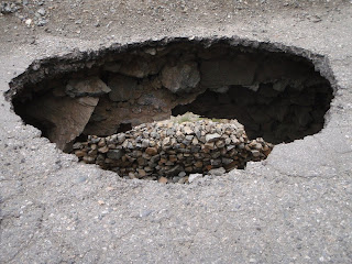 a huge pothole in the Karakorum Highway