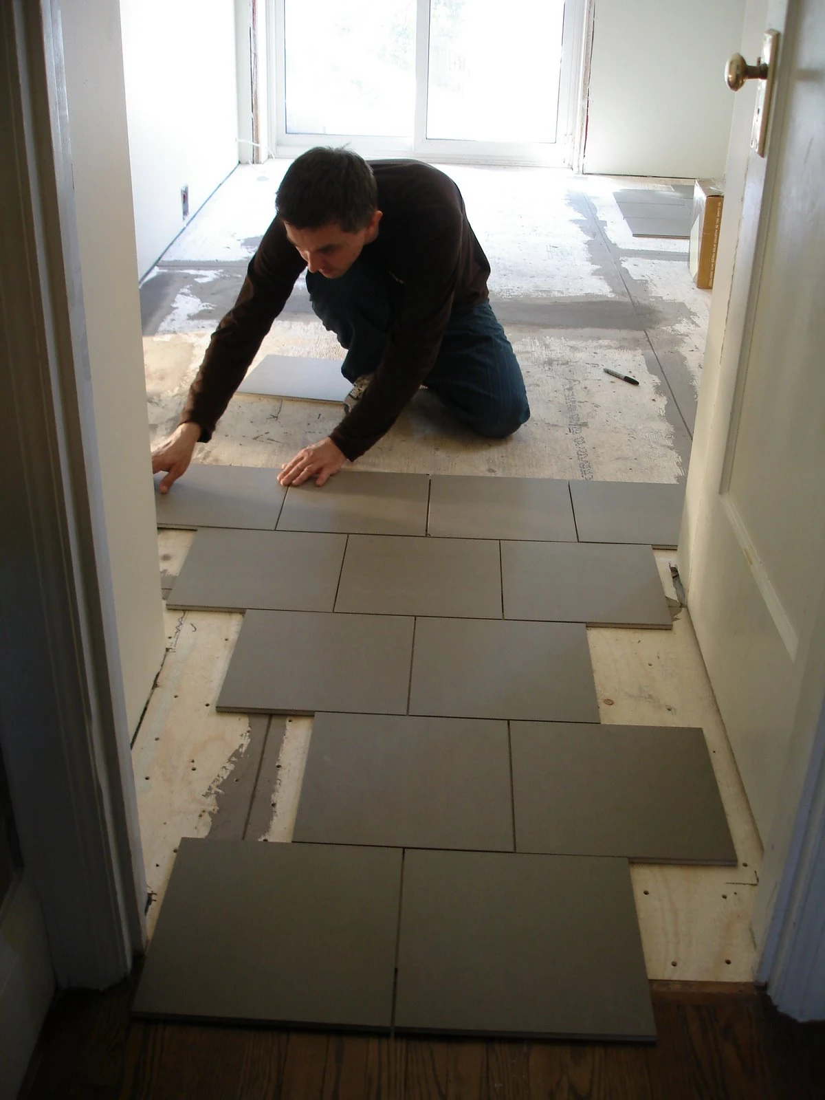 laying tile, diy tile floor