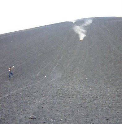 man sandboarding down volcano