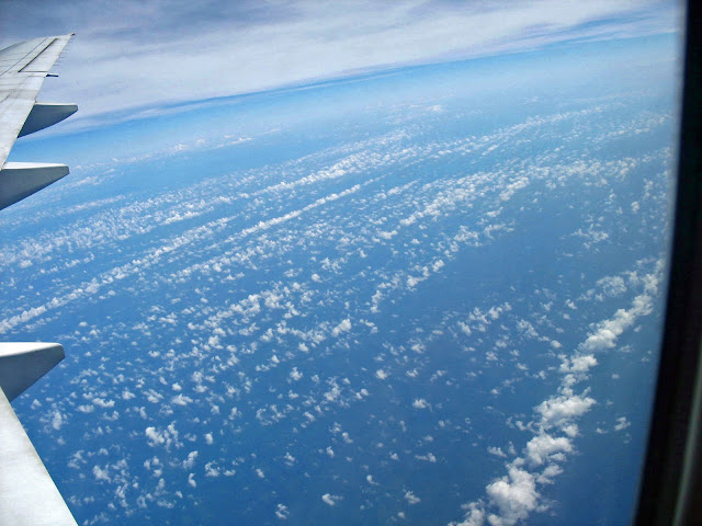 tiny fluffy clouds over the ocean