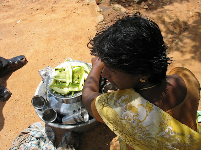 young woman selling raw mango slices in India