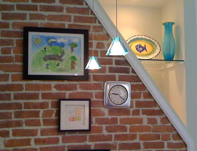 Kitchen after remodeling with exposed brick accent wall