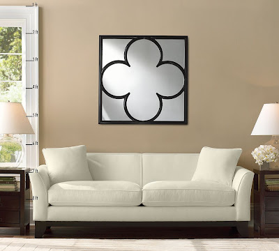 Light Colored Bedroom Furniture on The Clover Mirror On A Taupe Wall Hanging Over A White Sofa With Two