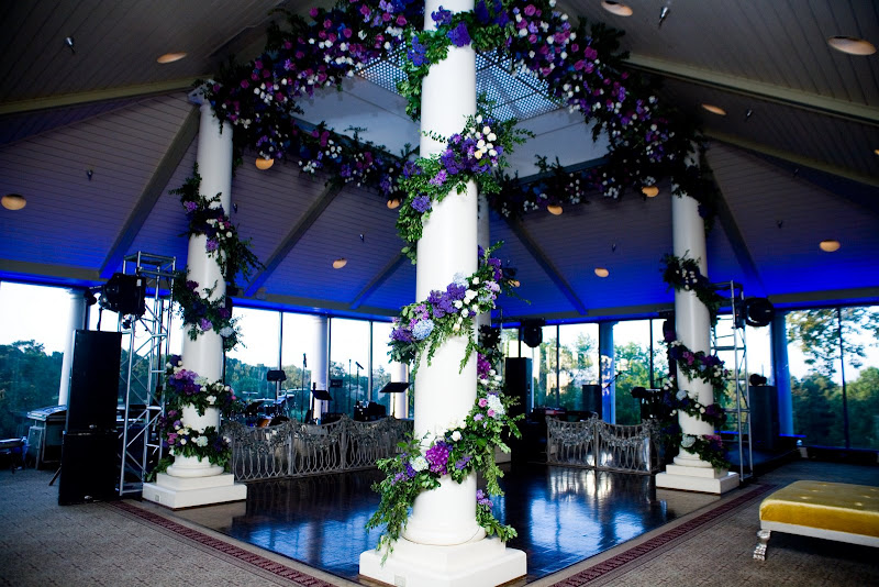 Wedding reception dance floor is flanked by four white classic columns 