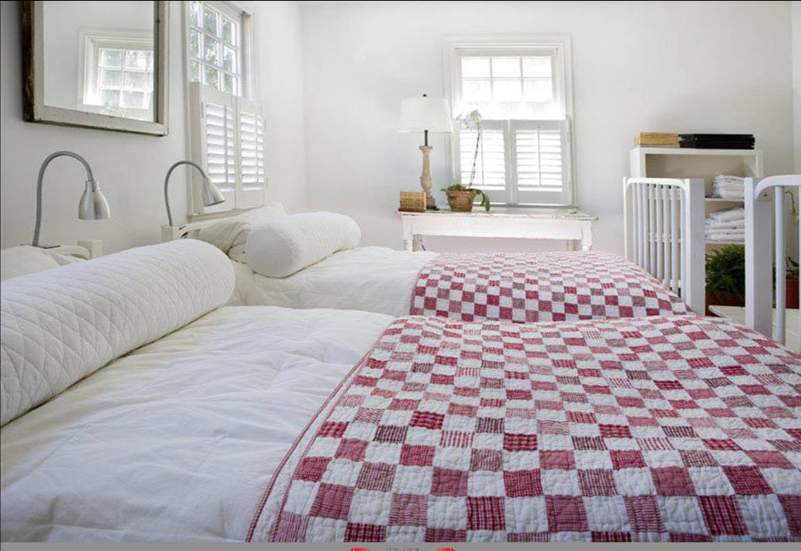 [eric+roth+bedroom+two+beds+red+white+checkered+check+quilt+quilted+neck+roll+pillow+bolster+chair+rail+headboard.jpg]