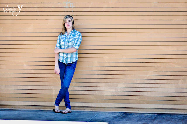 Senior picture in las vegas by JamieY Photography Senior picture of girl standing in front of roll up garage, hip urban setting, taken outdoors at town square in las vegas.