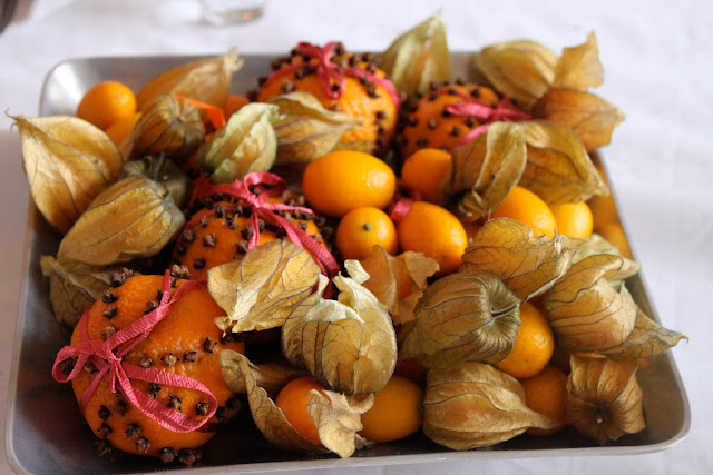 I studded tangerines with cloves and tied ribbon around them, you can do this with any citrus fruit, smells lovely.